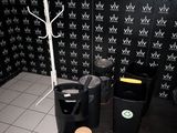 a black and white photo of a bathroom with black and white wallpaper