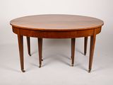 an oval dining table with four legs and a wooden top