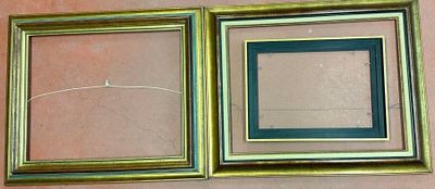 two picture frames hanging on the wall next to each other