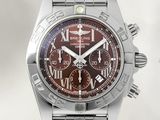 a close up of a stainless steel watch with a brown dial