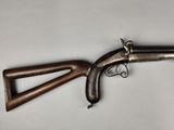 an old gun with a wooden handle on a white background