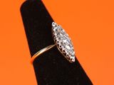 a close up of a diamond ring on a black ring stand