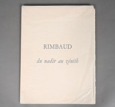 a white book sitting on top of a table covered in paper