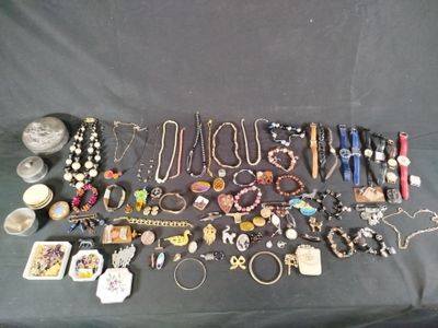 many different types of jewelry on a black table