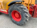 a tractor that is parked on the side of the road