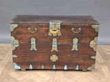 a wooden chest sitting on top of a hard wood floor