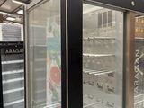 an image of a refrigerator in a store with glass doors