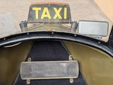 a taxi sign on the back of a taxi cab