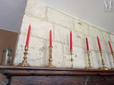 five red candles sitting on top of a mantle