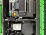a green case with a remote and other items in it