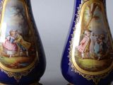 two vases that have been painted with pictures on them