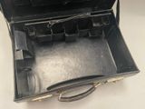 a black briefcase that is open on a white table