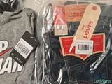 two pairs of jeans and a t - shirt in a plastic bag
