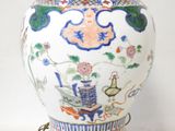 a vase with a chain around it on a table