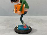 figurine of a boy with a book on a table