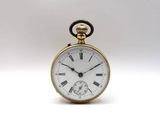 a gold pocket watch with roman numerals on the face