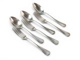 four silver spoons and two silver spoons on a white surface