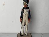 a toy soldier that is standing on a table