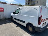 a white van parked in a parking lot next to a building