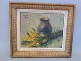 tableau représentant un vase orné de fleurs jaunes, dans un cadre doré