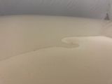 a white toilet with a white seat and a white tank