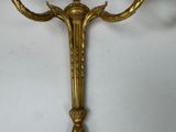 a gold colored candle holder with a candle on top of it