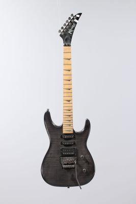an electric guitar hanging from a string on a white background