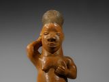 une image représentant une figurine d'un homme portant un chapeau sur la tête