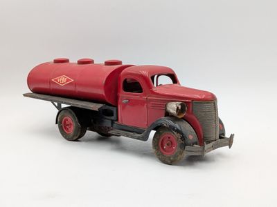 a red toy truck with a red tank on the back of it