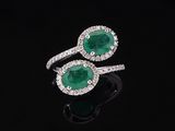 a pair of emerald and diamond rings