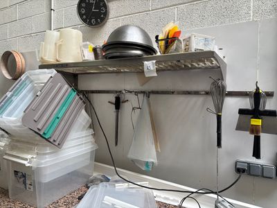 une cuisine équipée d'une cuisinière, d'un évier et d'autres objets posés sur le plan de travail