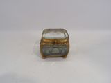 a small gold box with a blue stone inside of it