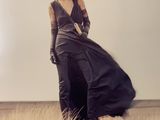 a woman that is standing on a hill in a dress