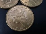 three silver coins sitting on top of each other on a blue surface