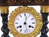 a black and gold clock sitting on a table