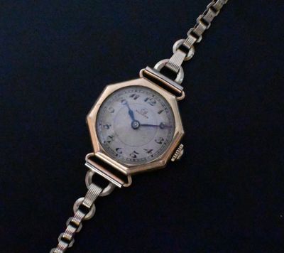 an image of a close up of a wrist watch on a chain