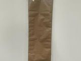 a brown paper bag hanging on the wall next to a bed