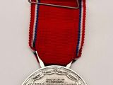 silver medal with red ribbon on white background with blue and red ribbon