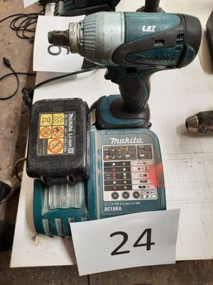 a drill and a cordless drill sitting on a table