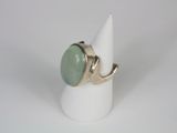 silver ring with a green stone on top of a white cone