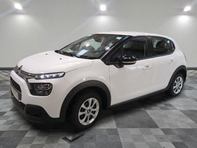 the white citrole is parked on a checkered tile floor