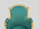 an image of a chair with a blue upholstered back and gold trim