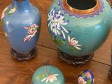 three vases sitting on a table next to each other