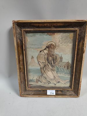 an old picture of a man holding a cross in a wooden frame