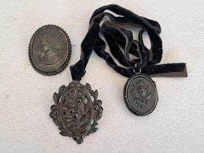 two medals and a medal on a white surface