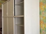 an image of a closet in a room with a wallpapered wall