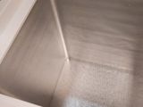 a stainless steel sink in the corner of a kitchen