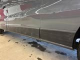 a van that has been painted silver with a red star on the side