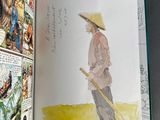 an open book with a picture of a man in a straw hat