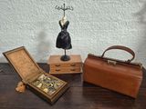 three pieces of jewelry sitting on a table next to a purse